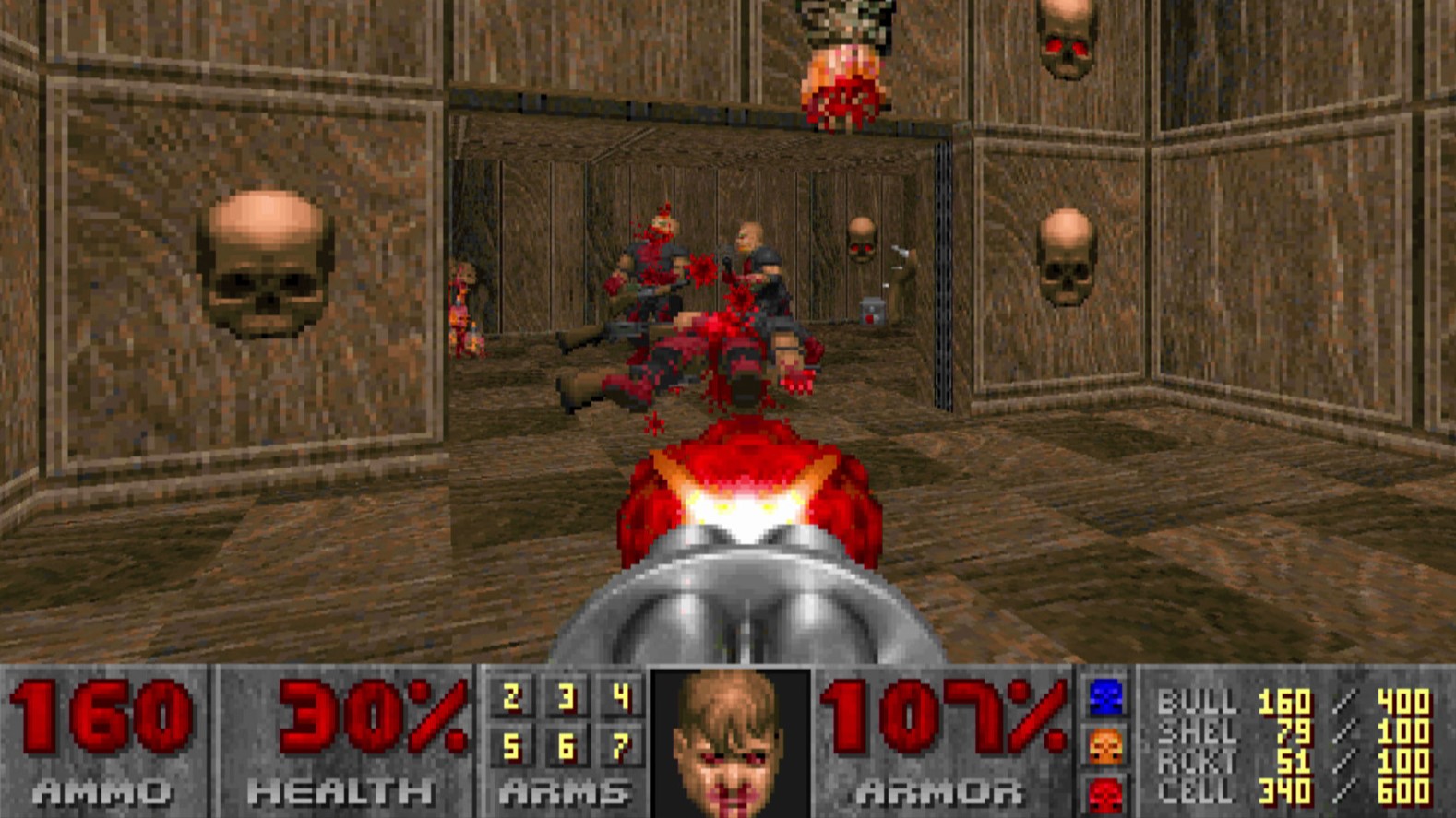 Screenshot from 1993 Doom showing enemies being shot in a room with skulls